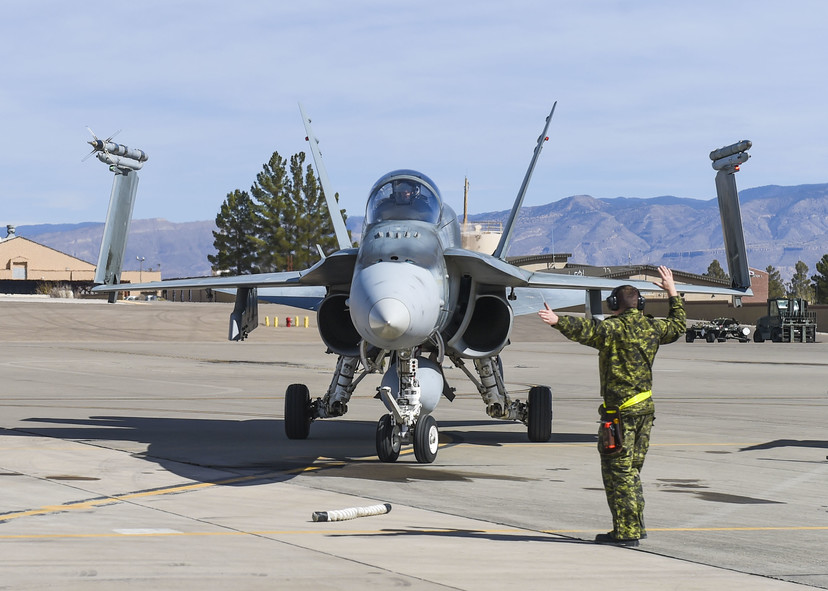 RCAF member directs a CF-18 Hornet at Holloman Air Force Base NM 13 Feb 2018 - USAF photo by SA Chase Cannon 180213-F-GO091-073
